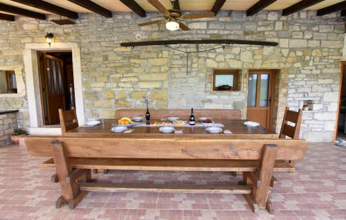a large wooden table in a stone room with a tableablish at Vila Vesna in Grožnjan