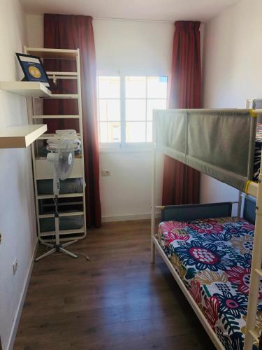 a room with two bunk beds and a desk at Sky Loft Tenerife in Palm-Mar