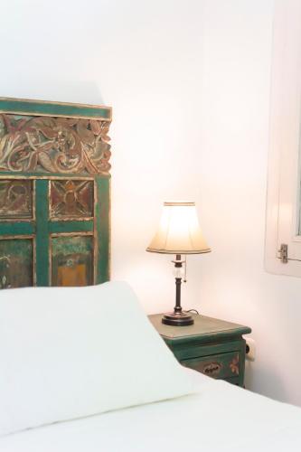 a bedroom with a bed and a lamp on a table at Villa Moya Borobudur in Mendut