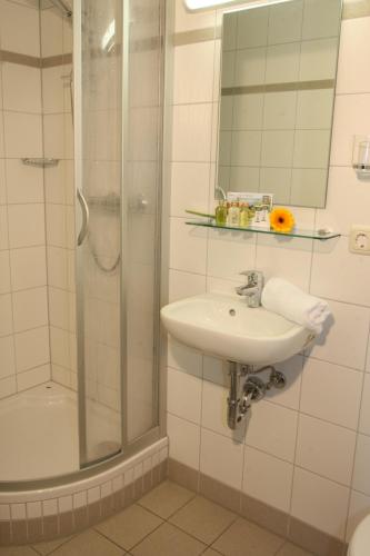 a white bathroom with a sink and a shower at Arberschutzhaus in Bayerisch Eisenstein