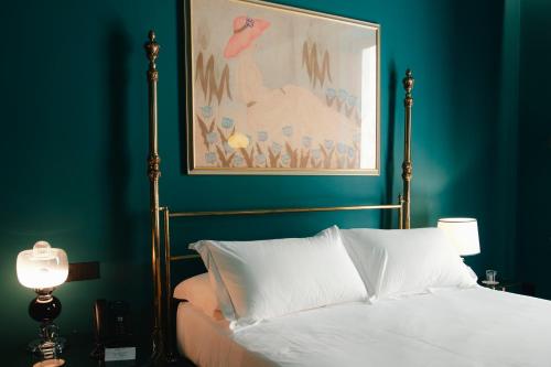 a bedroom with a bed and a painting on the wall at Fiermonte Museum by La Fiermontina in Lecce