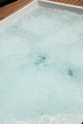 a bath tub filled with blue water with bubbles at Fiermonte Museum by La Fiermontina in Lecce