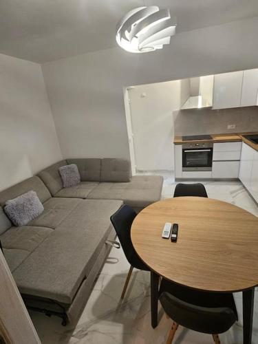 a living room with a couch and a table at Apartman Bruna in Split