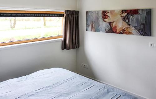 a bedroom with a bed and a painting on the wall at Stunning Home In Ijhorst With Wifi in IJhorst