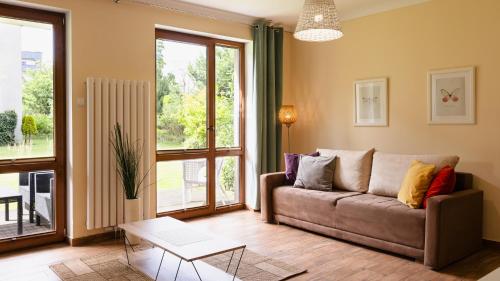 a living room with a couch and a table at Wczasowa, Sun & Snow in Ustka
