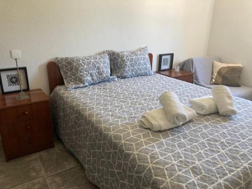 a bedroom with a bed with two pillows on it at Casa da Avó Ana - Montargil in Montargil