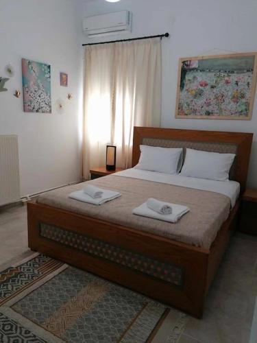 a bedroom with a bed with two towels on it at Giannis house in Makri