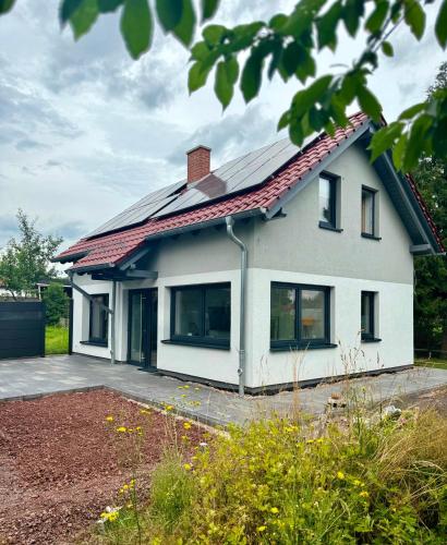 a house with solar panels on the roof at Ganzes Tiny House "Thüringer Ruhe" mit großem Garten nahe Rennsteig in Laucha