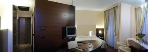 a large hotel room with a living room at Hotel Habitat in Giussano