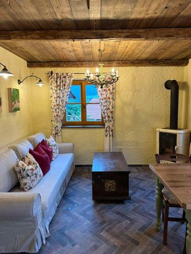 a living room with a couch and a table at Rose garden in Ljubno