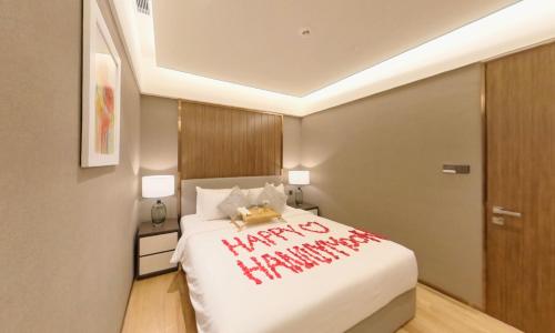 a bedroom with a happy new year written on a bed at Imperial KLCC Residence in Kuala Lumpur