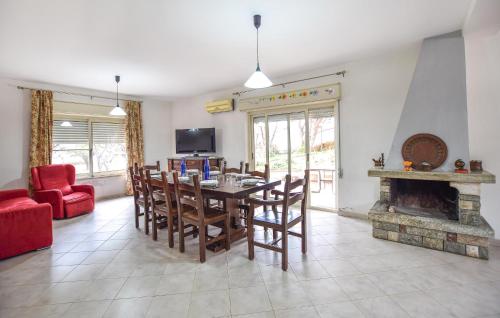 a dining room with a table and a fireplace at Amazing Home In Reggio Calabria in Reggio Calabria