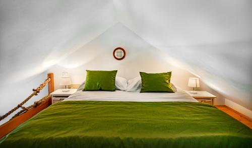 a bedroom with a green bed with two lamps at Seaside Apartments Bol in Bol