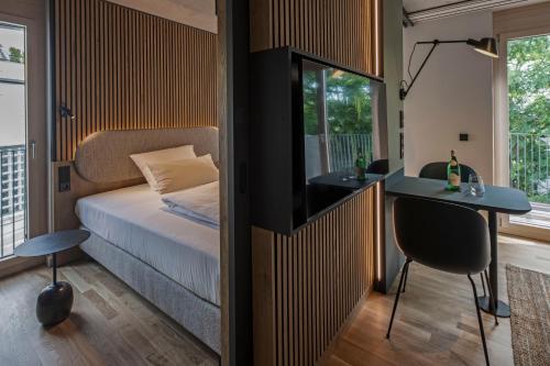a small bedroom with a bed and a desk and a desk at B5 Apartments in Karlsruhe