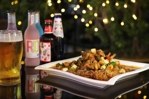 a plate of food on a table with a glass of beer at Holiday Inn Express Zhengzhou Zhongzhou by IHG in Zhengzhou