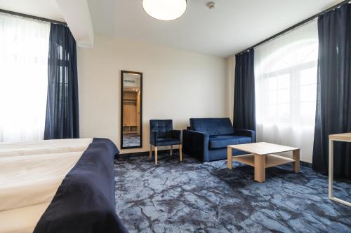 a hotel room with a bed and a chair at Ignasiak Hotel in Września