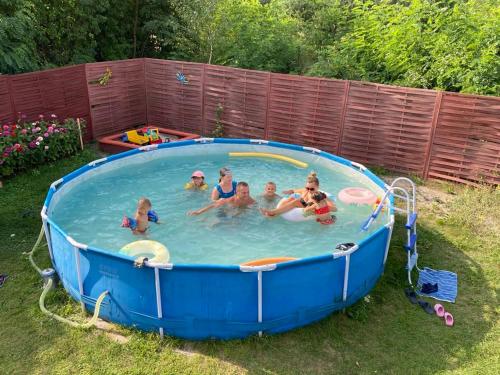 a group of people sitting in a pool at Zacisze u Rysia in Brochów
