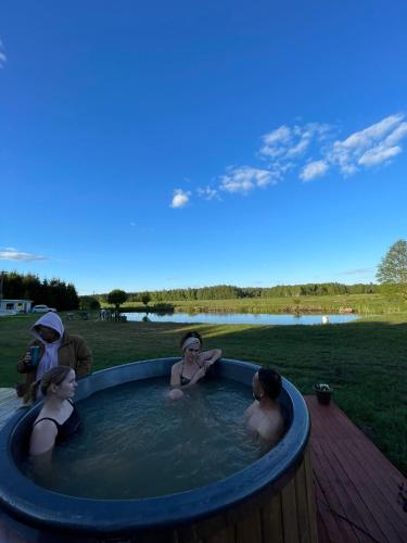 a group of people sitting in a hot tub at Żurawi Staw- siedlisko obok Augustowa in Augustów