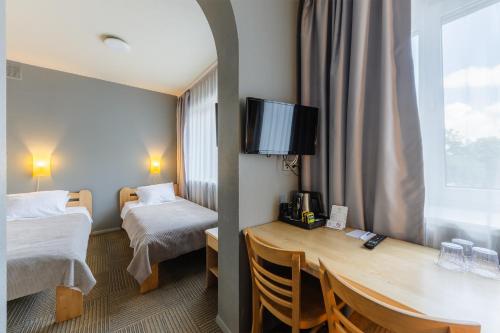 Ένα ή περισσότερα κρεβάτια σε δωμάτιο στο Liva Hotel