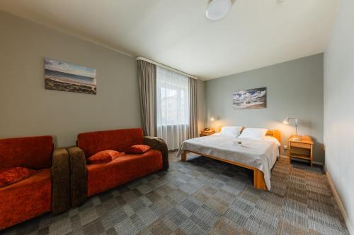 Ένα ή περισσότερα κρεβάτια σε δωμάτιο στο Liva Hotel