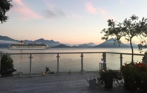 a cruise ship on the water with mountains in the background at Pet Friendly Home In Mauseidvåg in Holen