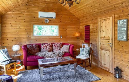 a living room with a red couch and a table at 2 Bedroom Pet Friendly Home In Haddal in Haddal