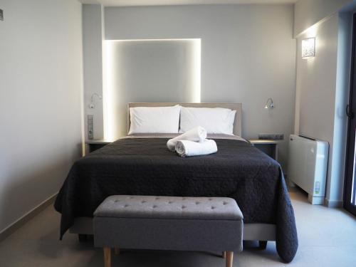 a bedroom with a bed with a white stuffed animal on it at Golden Sand Suites 2 in Anavissos