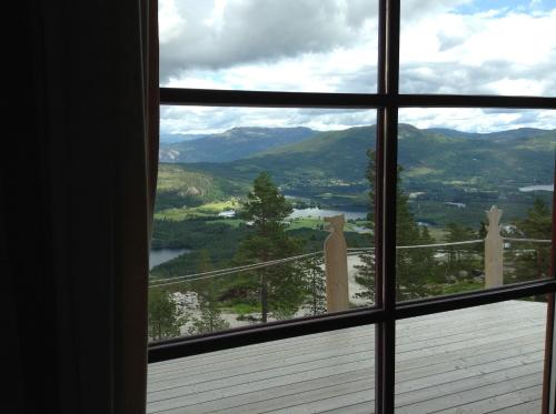 a window view of a mountain view from a house at Weitblicken - Cosy Holiday Home with stunning views in Vradal