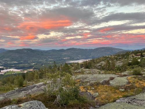 a view from the top of a mountain at sunset at Weitblicken - Cosy Holiday Home with stunning views in Vradal