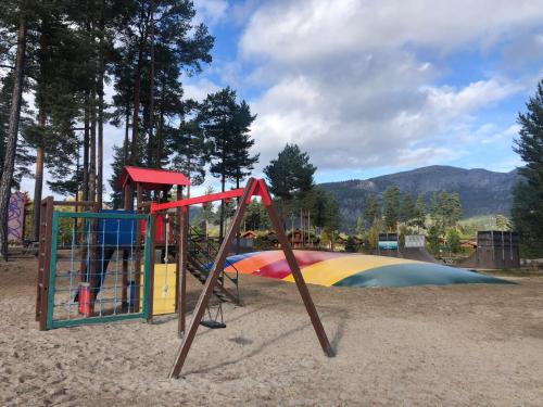 a playground with a slide in the sand at Weitblicken - Cosy Holiday Home with stunning views in Vradal
