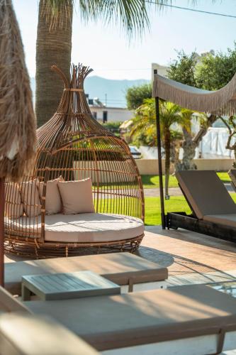 a swinging chair on a patio with a hammock at Ammos Boutique Apartments & Suites in Malia