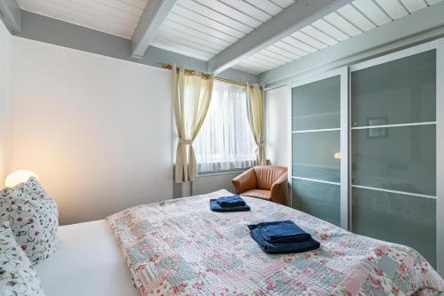 a bedroom with a bed with two blue towels on it at Atlanta Pur in Pellworm