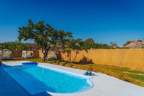 a swimming pool in a yard with a fence at Casa Ilinca in Jurilovca