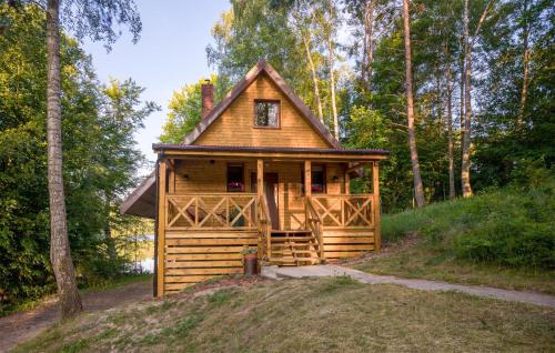 a tiny house in the woods with a porch at 2 Bedroom Awesome Home In Bobolice in Bobolice