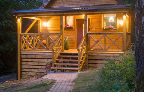 a wooden cabin with stairs leading to the door at 2 Bedroom Awesome Home In Bobolice in Bobolice
