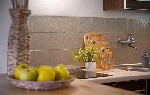 a kitchen with a bowl of apples on a counter at 2 Bedroom Awesome Home In Bobolice in Bobolice