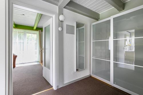 an empty room with glass doors and a hallway at Atlanta Pur in Pellworm