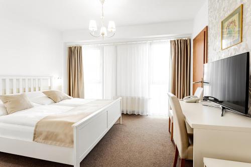 Postel nebo postele na pokoji v ubytování Hotel Šariš