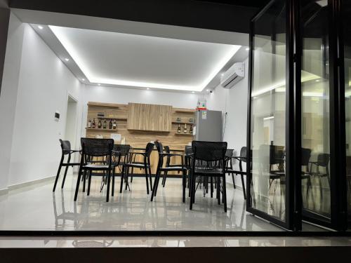 a dining room with black chairs and a table at Villa Papa-Berat in Berat