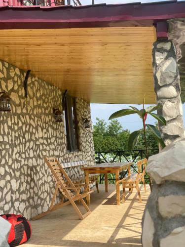 a wooden table and chairs on a patio at Kirta in Gordi