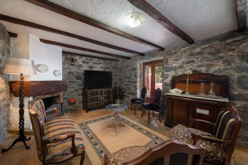 a living room with a stone wall at Villa Roque by An Island Apart in Calheta