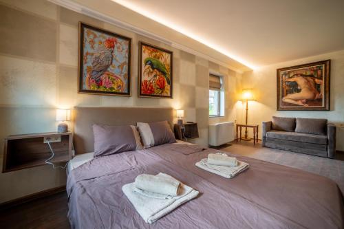 a bedroom with a large bed with towels on it at Stella Guesthouse in Arbanasi