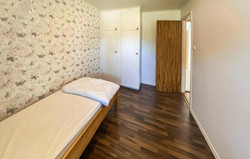 a small room with a bed and a door at 3 Bedroom Lovely Home In Alstermo in Alstermo