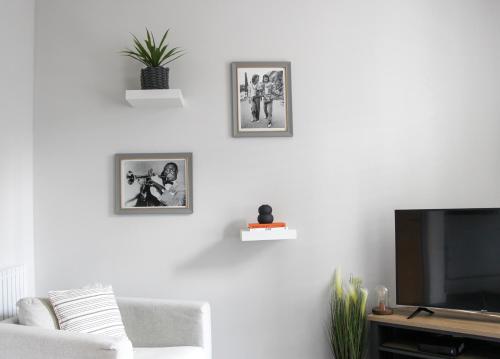 a living room with a tv and a couch at New, Luxury Apartment in Town Centre in Cheltenham