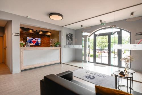 a living room with a couch and a table at Ignasiak Hotel in Września