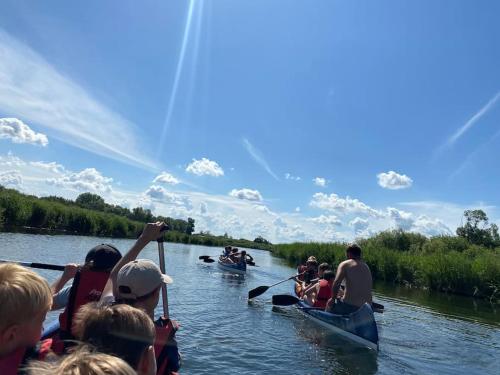 a group of people in kayaks on a river at FeWo Fehmarn Mecklenburg Pool Alte Schule Barlin in Dargun