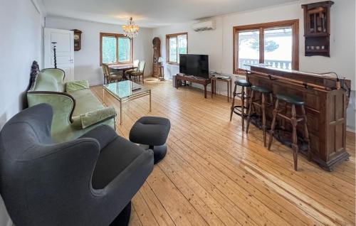 a living room filled with furniture and a piano at 4 Bedroom Amazing Home In Sorunda in Hästnäs