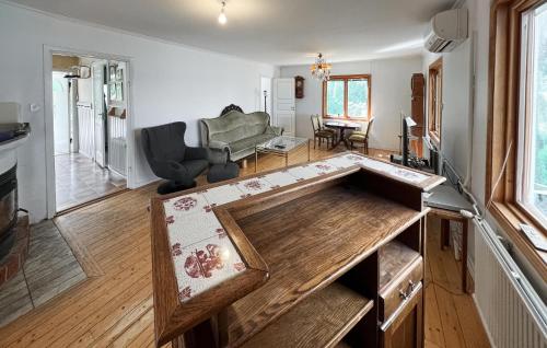 a living room with a large wooden table in the middle at 4 Bedroom Amazing Home In Sorunda in Hästnäs