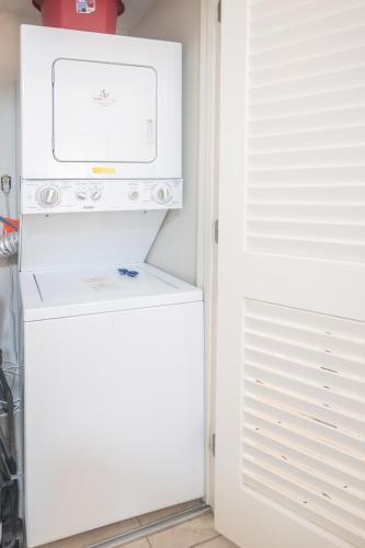 a kitchen with a refrigerator and a microwave at The Surf Shack in Destin