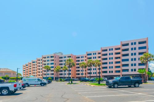a parking lot with cars parked in front of a large building at The Surf Shack in Destin